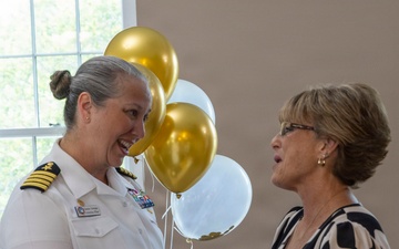 Capt. Chandra "Mamasan" Newman, Naval Air Station (NAS) Pensacola's commanding officer, presents a letter of appreciation to Navy-Marine Corps Relief Society (NMCRS) Relief Services Assistant Amanda Shadden recognizing her 20 years of service, June 5.