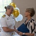 Capt. Chandra "Mamasan" Newman, Naval Air Station (NAS) Pensacola's commanding officer, presents a letter of appreciation to Navy-Marine Corps Relief Society (NMCRS) Relief Services Assistant Amanda Shadden recognizing her 20 years of service, June 5.