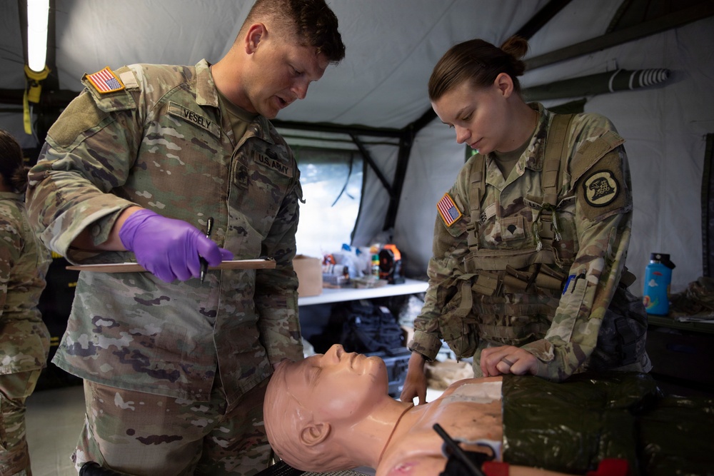 Sgt. Vesely and Spc. Weis Treat Patient - Hawkeye River Run