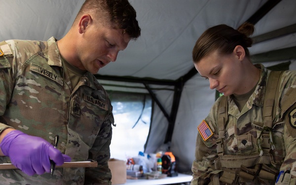 Sgt. Vesely and Spc. Weis Treat Patient - Hawkeye River Run