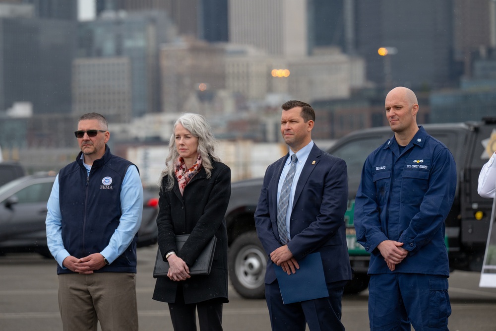 Federal, state, and local agency representatives participate in a media event at Coast Guard Base Seattle.