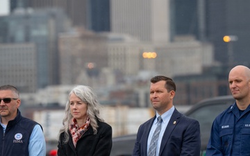 Federal, state, and local agency representatives participate in a media event at Coast Guard Base Seattle.