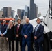 federal, state, and local agency partners pose for a group photo during a media event at Coast Guard Base Seattle.