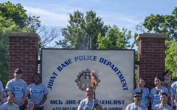 87th Security Forces Squadron carry Flame of Hope