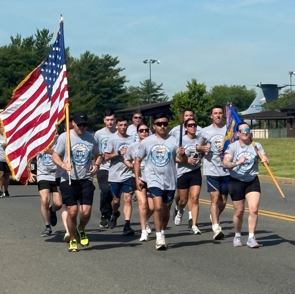 87th Security Forces Squadron carry Flame of Hope