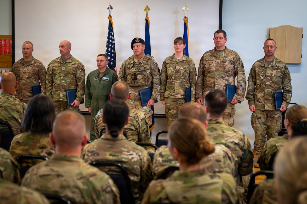 Airmen Stand at Attention at Induction Ceremony