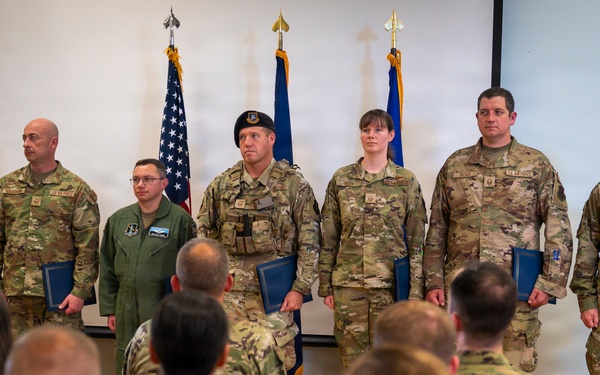 Airmen Stand at Attention at Induction Ceremony