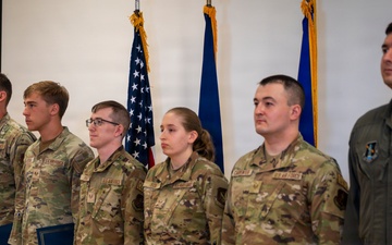 Airmen Stand at Attention at Induction Ceremony