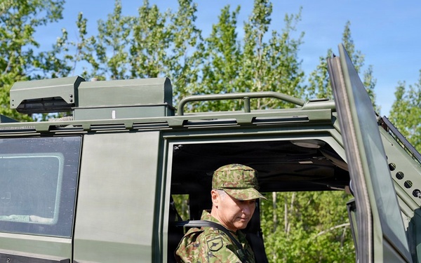 Japanese General Rides Arctic Combat Vehicle during JBER Tour