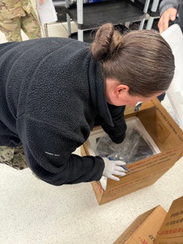 U.S. Navy Hospital Corpsman First Class Kristen Gordon prepares a temperature-controlled shipping container for blood products at the Armed Services Whole Blood Processing Laboratory-East