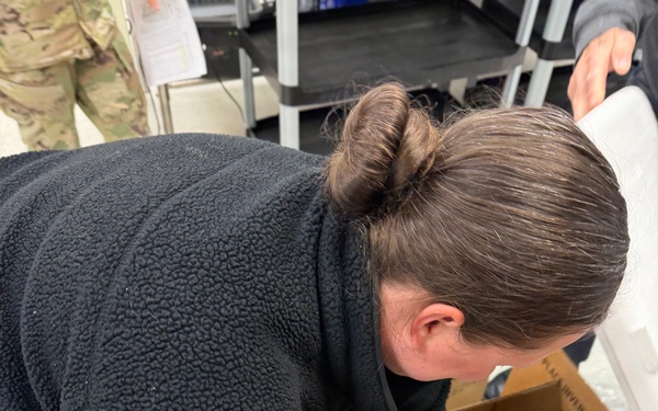 U.S. Navy Hospital Corpsman First Class Kristen Gordon prepares a temperature-controlled shipping container for blood products at the Armed Services Whole Blood Processing Laboratory-East