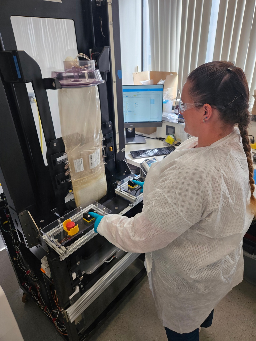 U.S. Navy Hospital Corpsman First Class Kristen Gordon Operates a Specialized Sealer for Spray-Dried Plasma Production