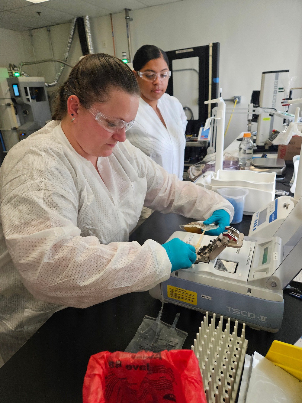 U.S. Navy Hospital Corpsman 1st Class Kristen Gordon and U.S. Air Force Tech. Sgt. Kiersten Zardee Conduct Spray-Dried Plasma Production Training.