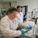 U.S. Navy Hospital Corpsman 1st Class Kristen Gordon and U.S. Air Force Tech. Sgt. Kiersten Zardee Conduct Spray-Dried Plasma Production Training.