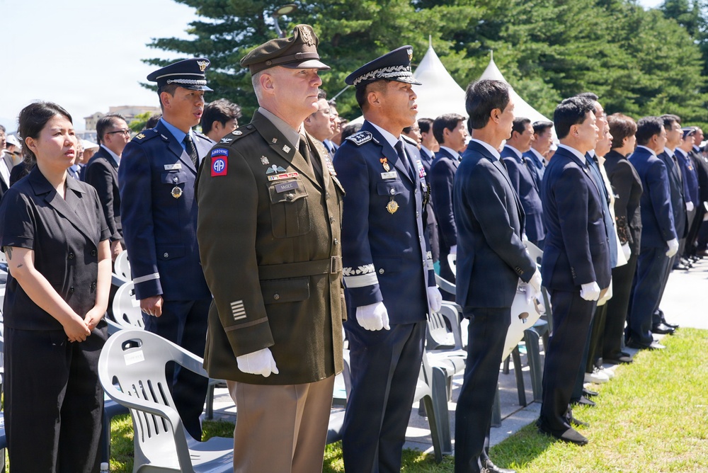 Attendees stand together for Korean national anthem