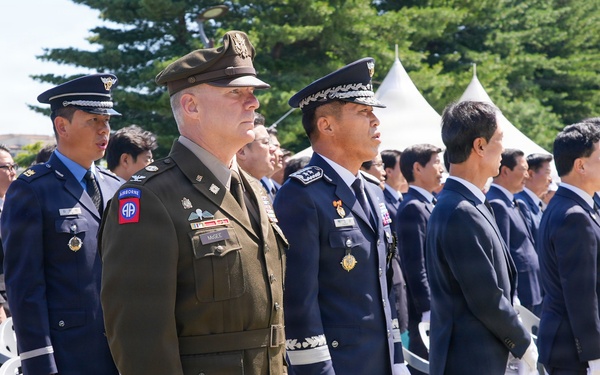 Attendees stand together for Korean national anthem