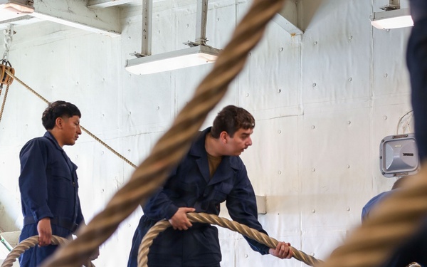 U.S. Sailors Heave A Mooring Line During Sea And Anchor Detail