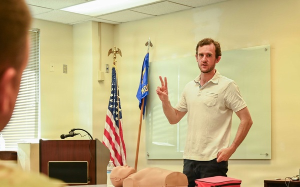 Luke Humphrey, CPR/AED and first aid instructor with Cardiac Care and Safety Inc., demonstrates life-saving techniques during a TAG Safety Stand Down