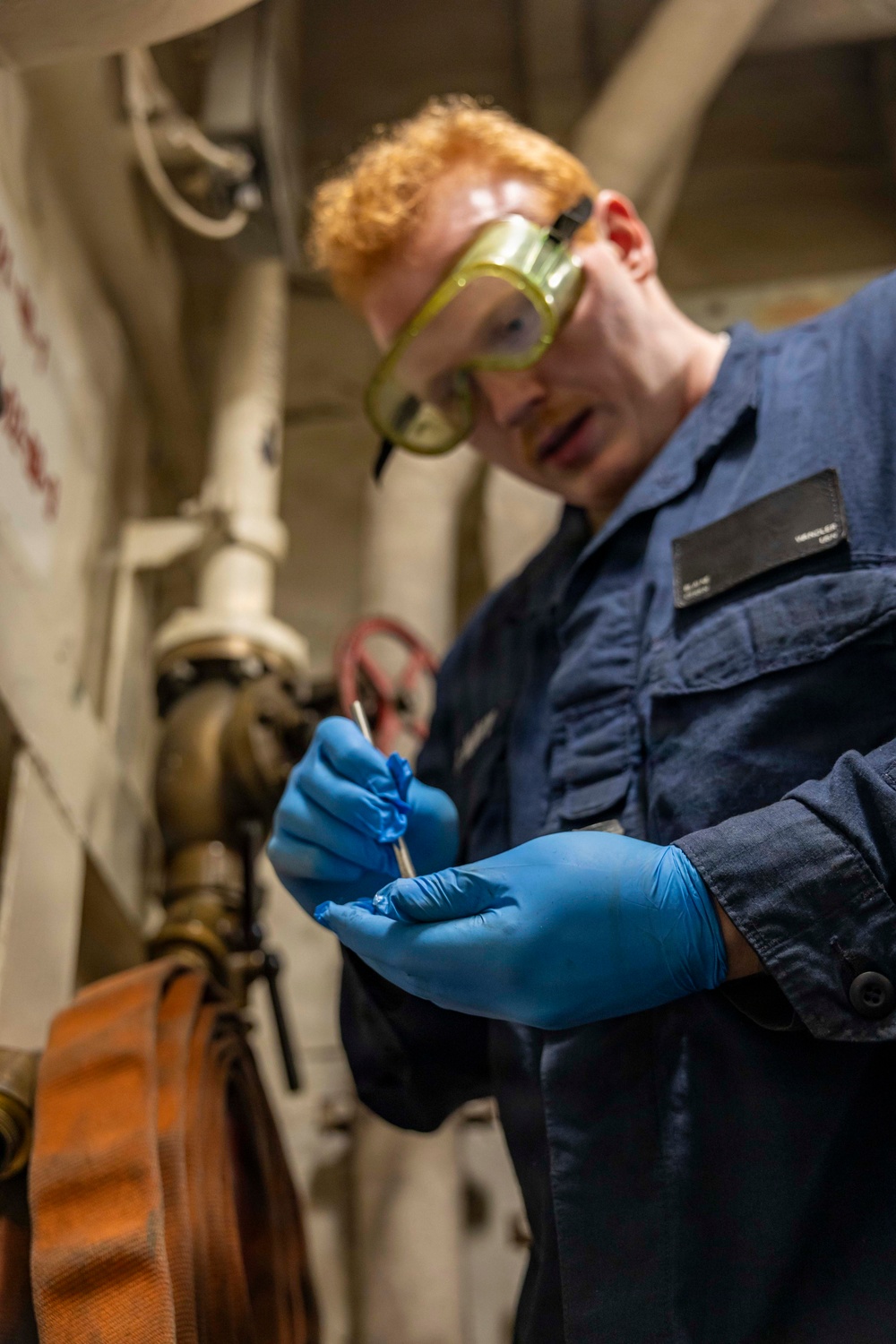 USS Iwo Jima Sailor Conducts Maintenance