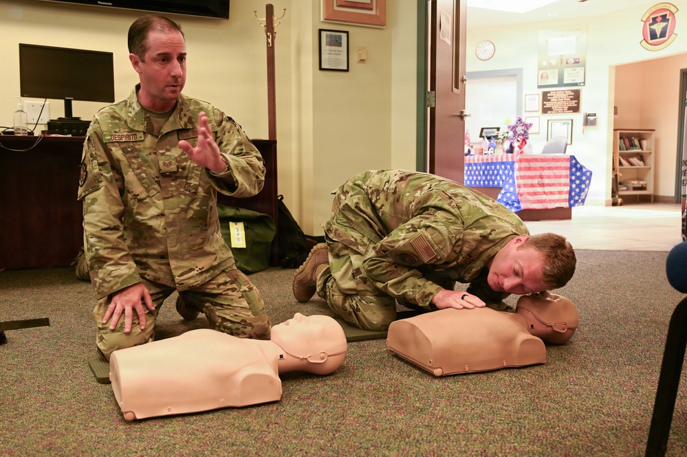 U.S. Air Force Staff Sgt. Despirito participates with a fellow airman as he demonstrates rescue techniques on a CPR training mannequin