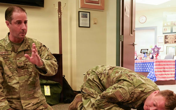U.S. Air Force Staff Sgt. Despirito participates with a fellow airman as he demonstrates rescue techniques on a CPR training mannequin