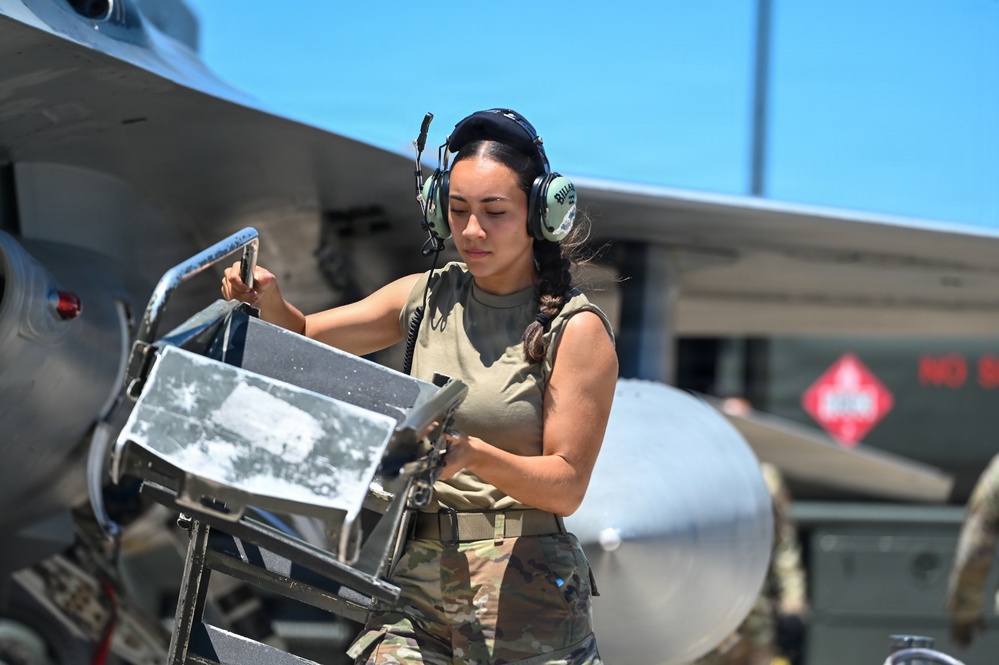 U.S. Air Force crew chief performs weapons load operations on F-16 Fighting Falcon on flight line