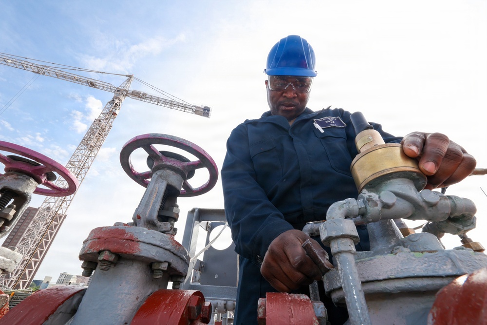 Bataan Sailors Sand a Fuel Station for Repainting