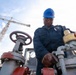 Bataan Sailors Sand a Fuel Station for Repainting