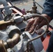 Bataan Sailors Sand a Fuel Station for Repainting
