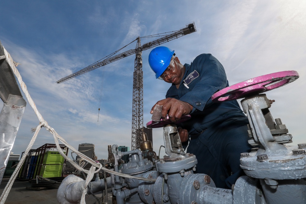 Bataan Sailors Sand a Fuel Station for Repainting