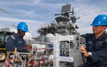 Bataan Sailors Sand a Fuel Station for Repainting