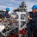 Bataan Sailors Sand a Fuel Station for Repainting