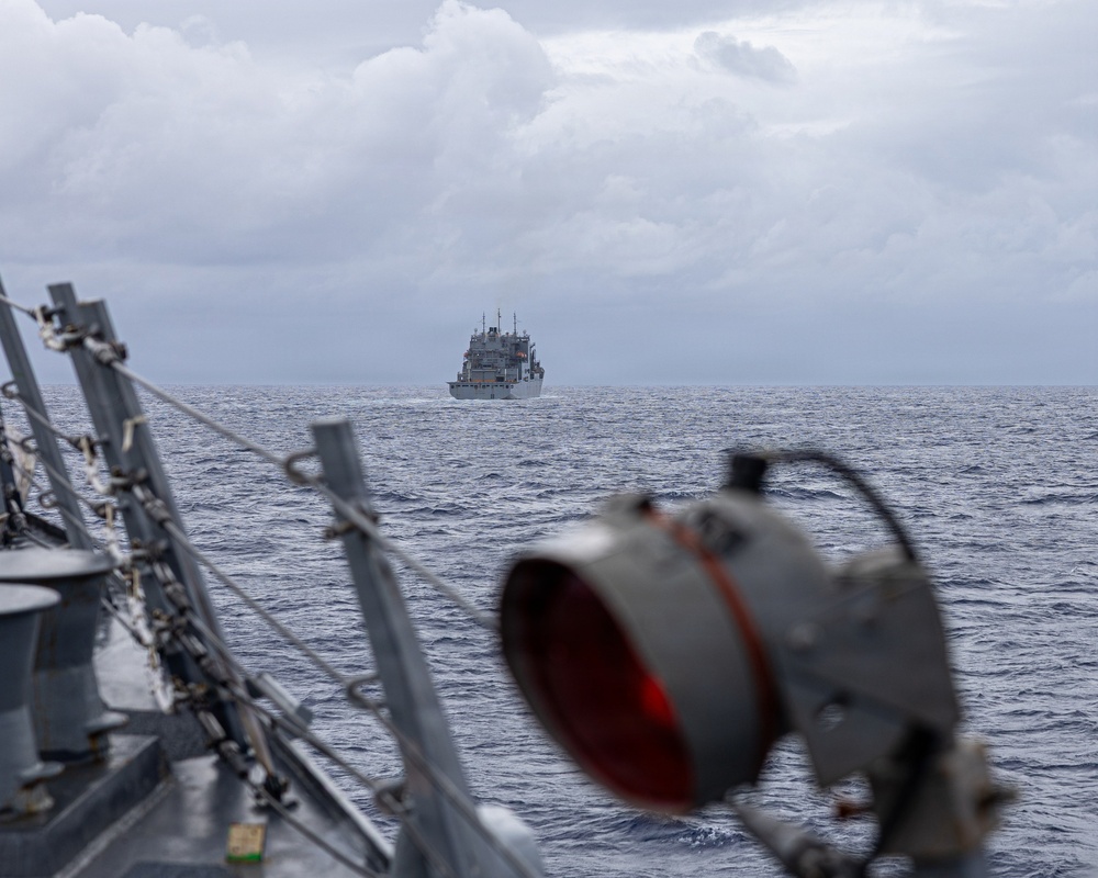 USS Mustin conducts a replenishment-at-sea with USNS Wally Schirra