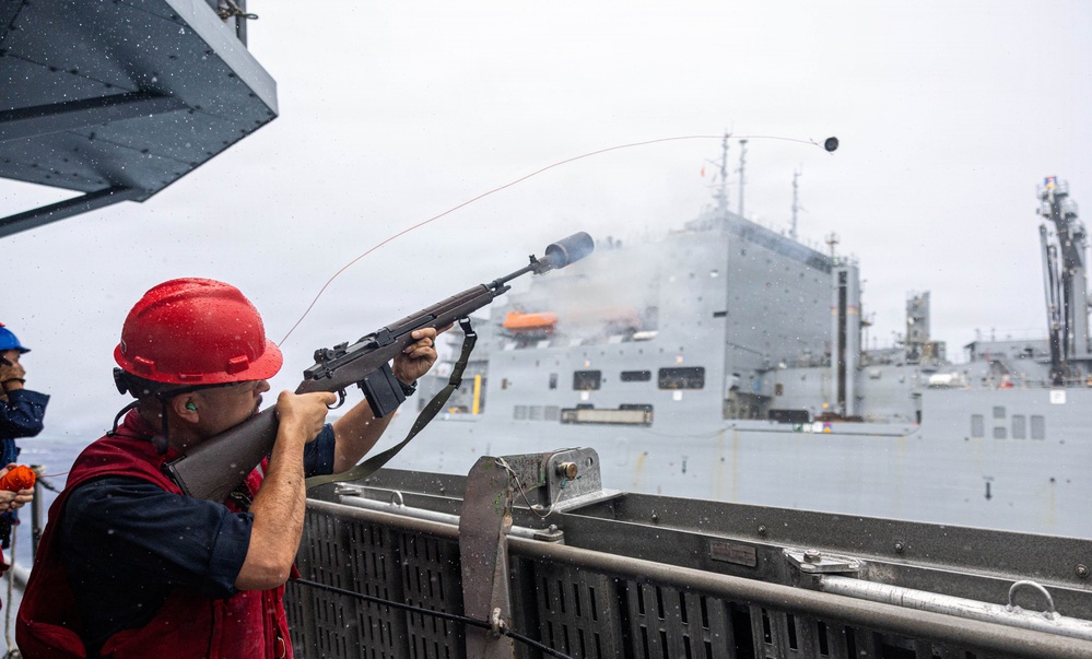 USS Mustin conducts a replenishment-at-sea with USNS Wally Schirra