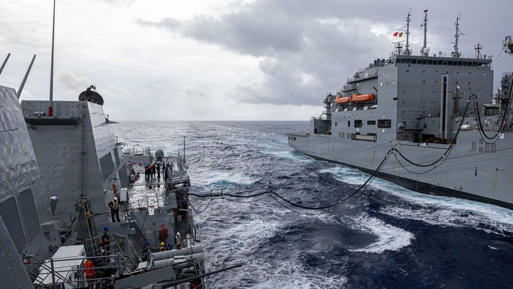 USS Mustin conducts a replenishment-at-sea with USNS Wally Schirra