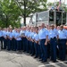 U.S. Coast Guard personnel pose for group photo with response boat during awards ceremony