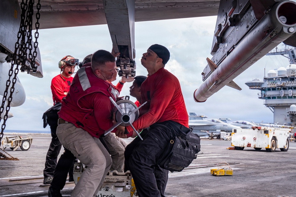 Nimitz Sailors Load Ordnance