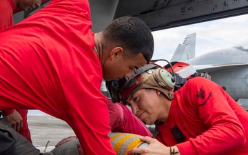 Nimitz Sailors Load Ordnance