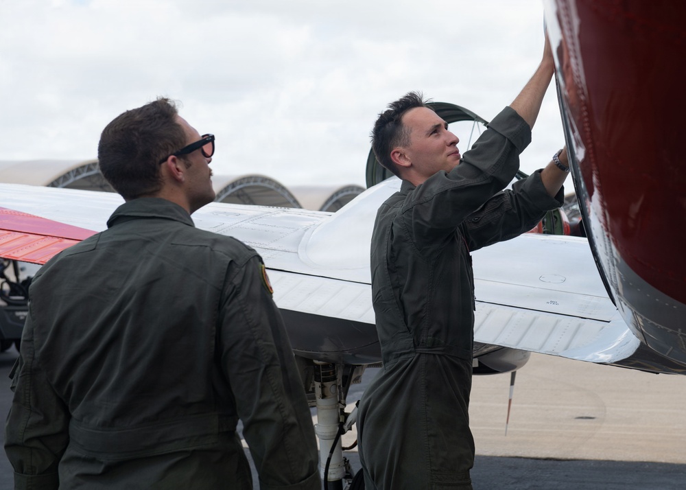 French Navy Aviator and a Student Naval Aviator Exit T-44C Pegasus After A Routine Training Flight