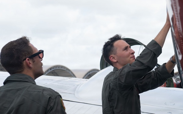 French Navy Aviator and a Student Naval Aviator Exit T-44C Pegasus After A Routine Training Flight