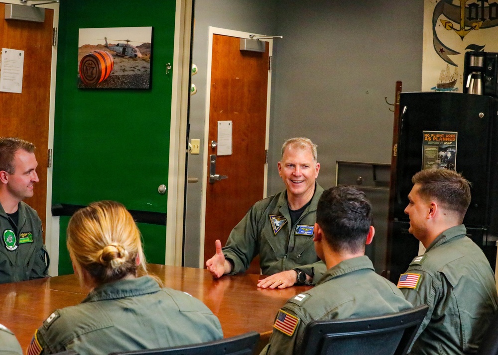 Rear Adm. Rich Brophy speaks with officers assigned HSC-7