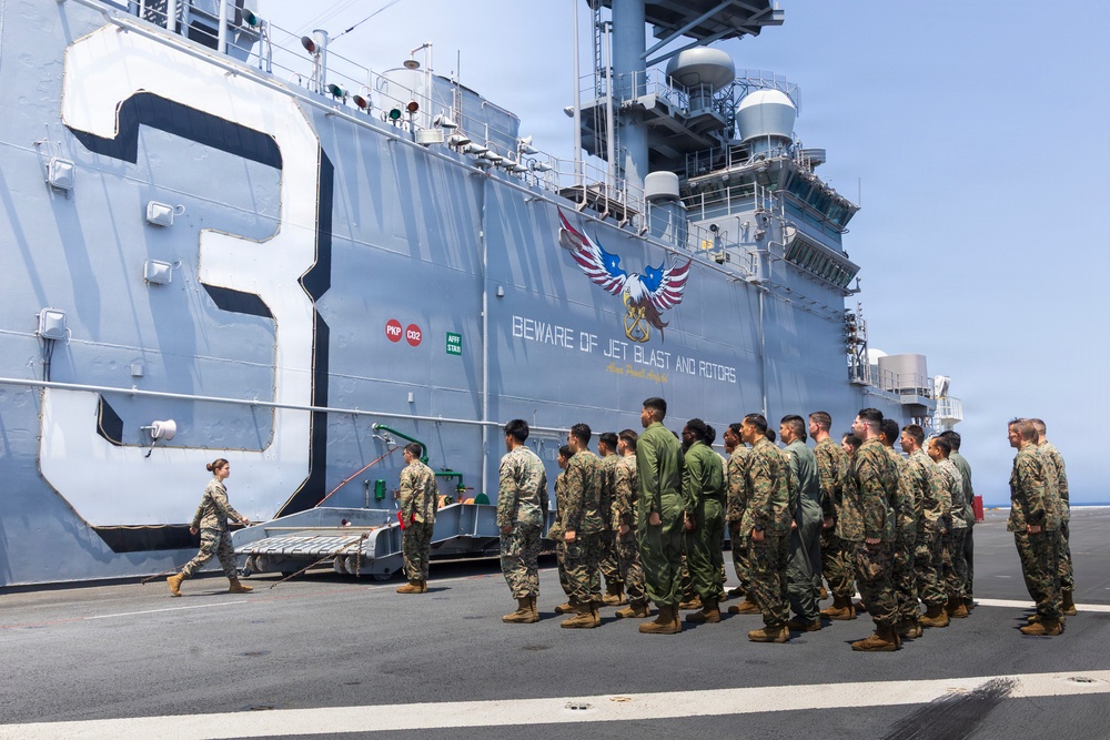 U.S. Marine with the 26th MEU reenlists on the USS Kearsarge