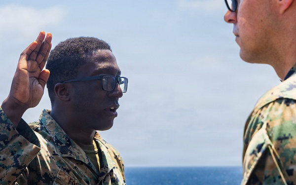 U.S. Marine with the 26th MEU reenlists on the USS Kearsarge