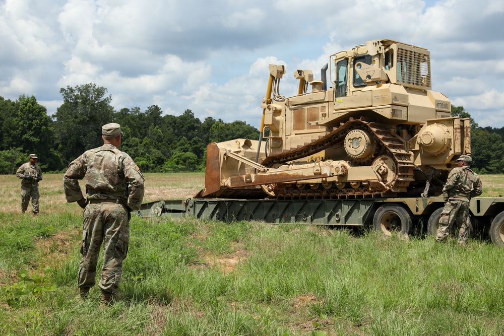 Army Reserve engineers deploy a bulldozer to dig defensive battle positions during Operation Sentinel Justice