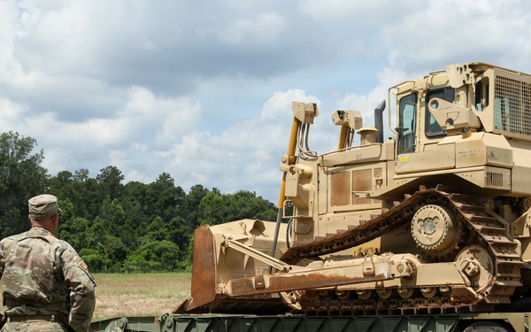 Army Reserve engineers deploy a bulldozer to dig defensive battle positions during Operation Sentinel Justice