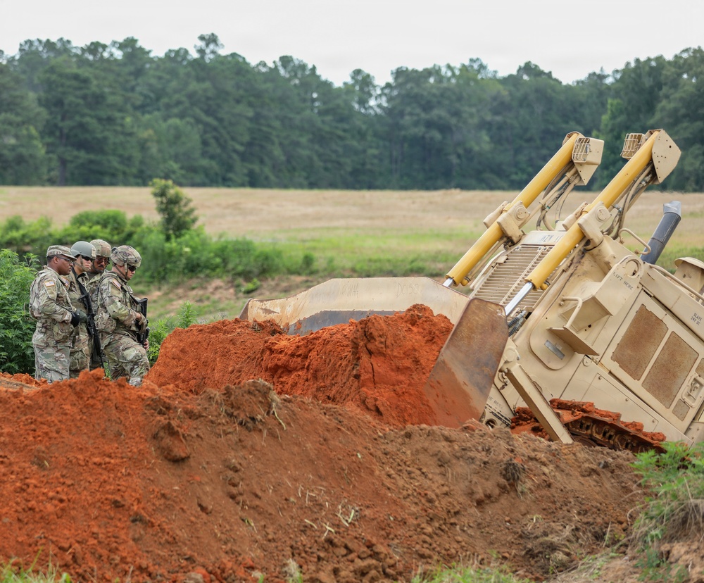 Army Reserve engineers deploy a bulldozer to dig defensive battle positions during Operation Sentinel Justice