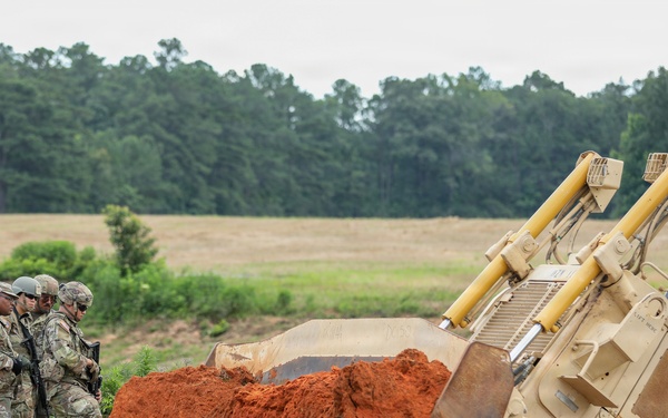 Army Reserve engineers deploy a bulldozer to dig defensive battle positions during Operation Sentinel Justice