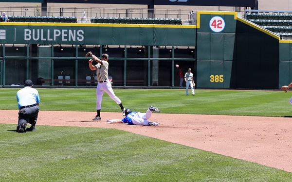 Infielder Fires to First as Runner Slides Into Second Base During Baseball Game