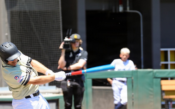 Batter swings patriotic red, white and blue bat during military appreciation baseball game