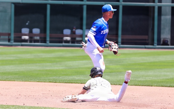 Base runner slides into second as Temple University infielder leaps to complete play during college baseball game